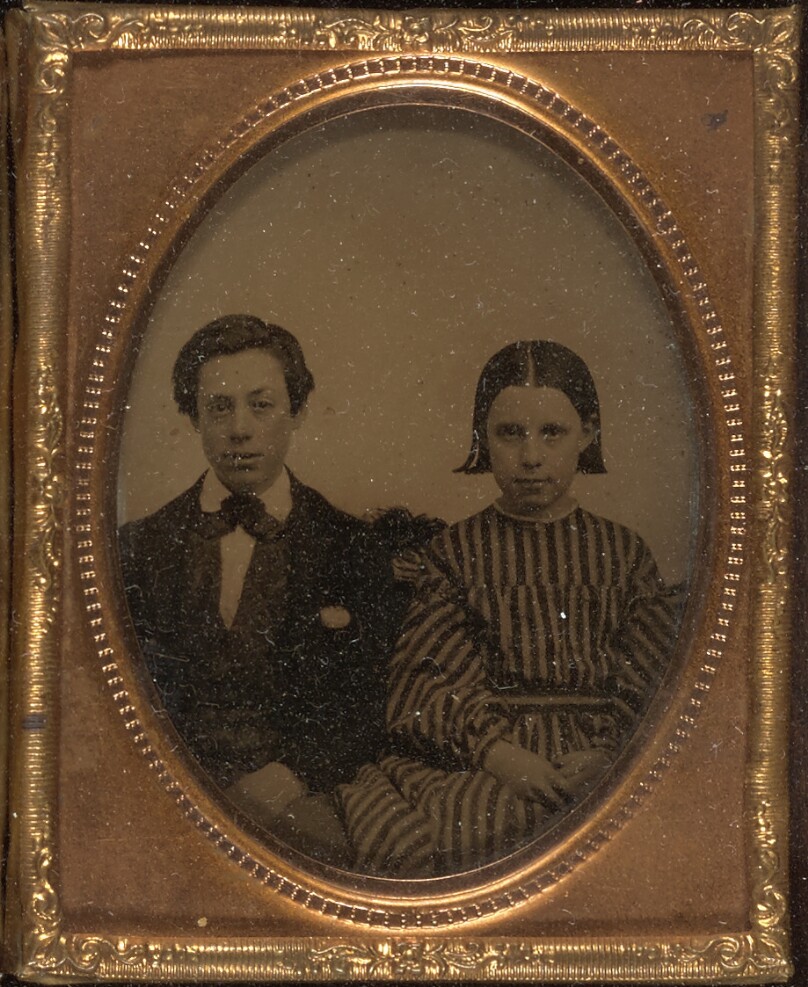 [Young boy and young girl seated]