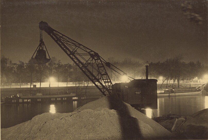 [Crane at work site by river]