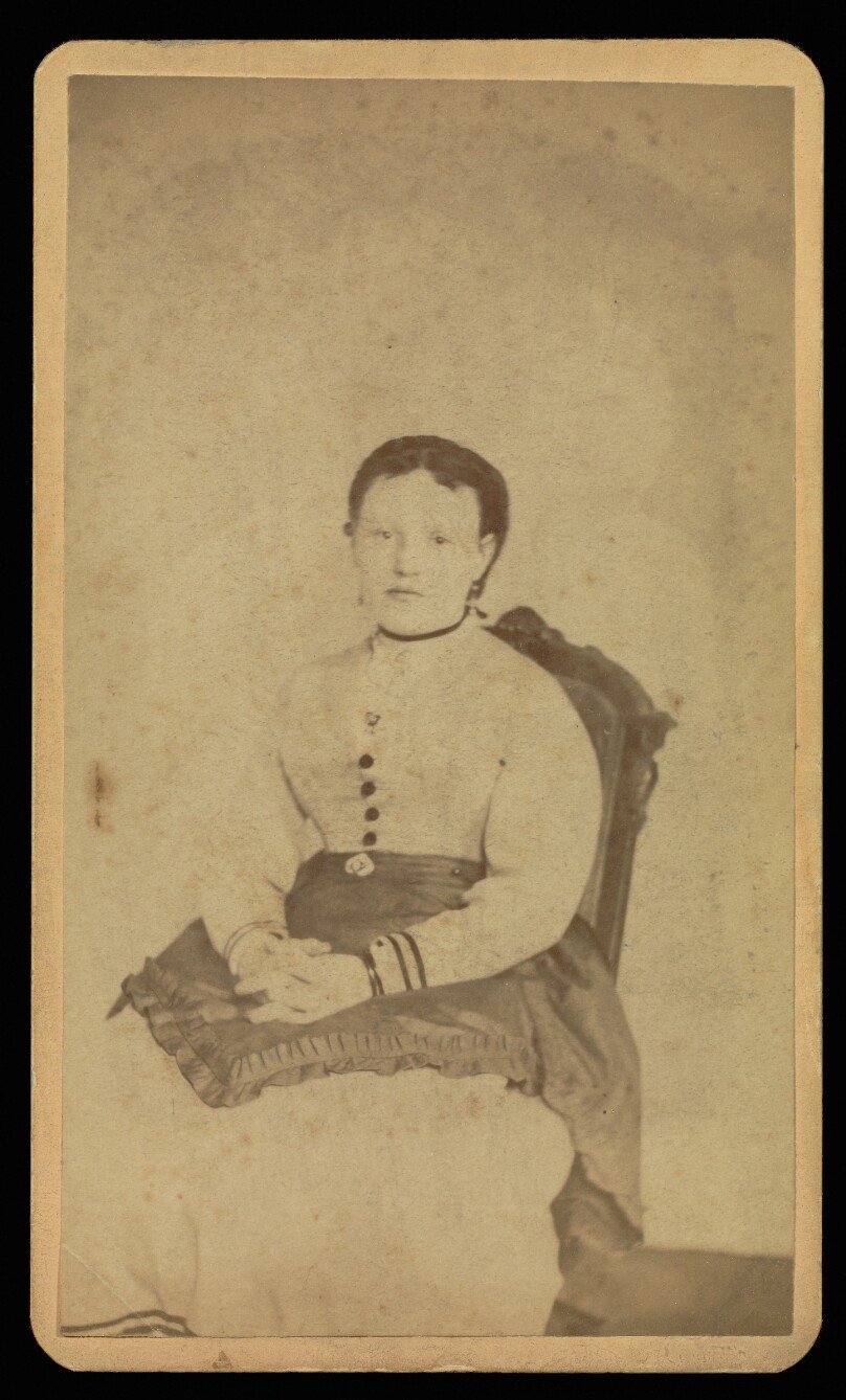 [Unidentified woman wearing a white dress seated with a "spirit"]