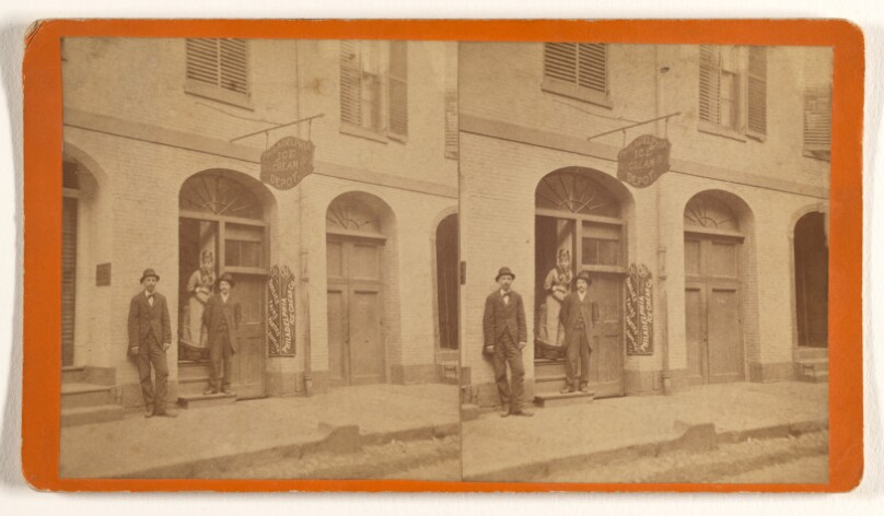 [Two men and a woman posed in doorway of The Philadelphia Ice Cream Depot]