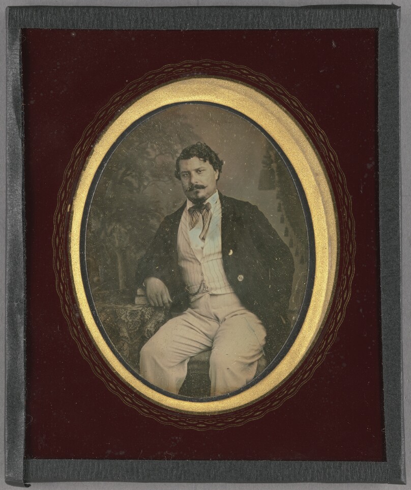 [Portrait of a Seated Man Resting Arm on Books]