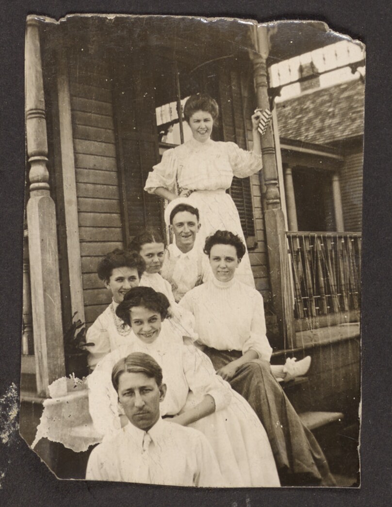 [Group portrait on porch steps]