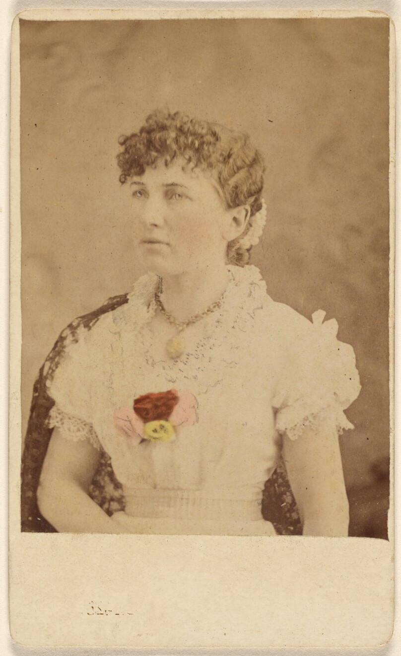 [Unidentified woman wearing flower embellished dress, seated]