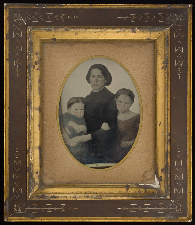 [Portrait of mother and two children]