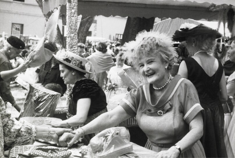 Selling potholders for the benefit of the Salvation Army. The charity bazaar also featured strolling musicians and a Brazilian-style barbecue.