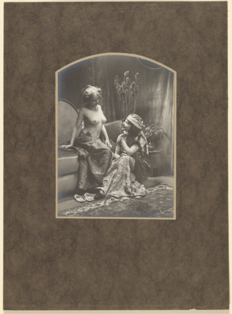 [Two women draped in fabrics]