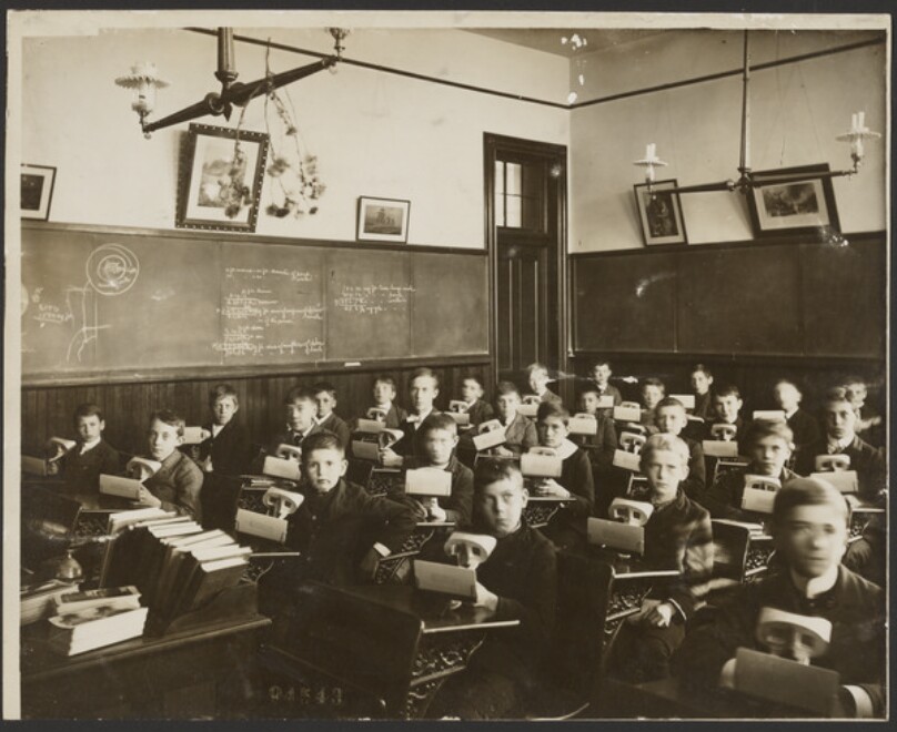[Classroom of boys looking at stereographs]