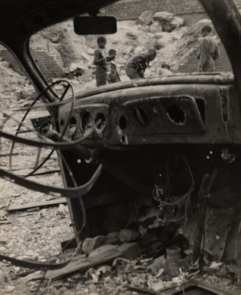 [Children playing in junk car lot]