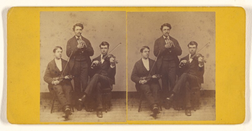 [Three musicians: one cornet player standing, two violinists seated]
