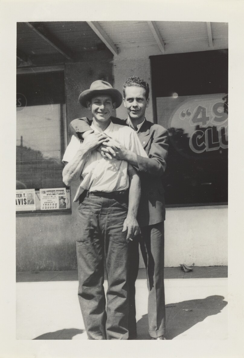 [Two men hugging]
