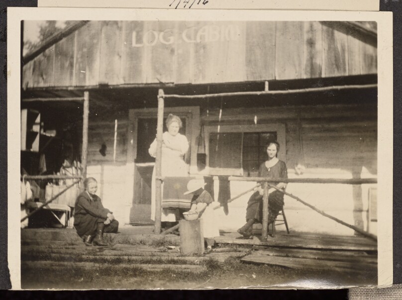 [Group posing on a porch]