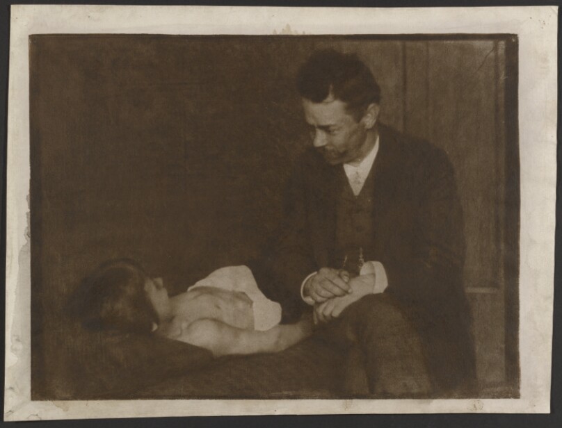 [Man Seated Beside Supine Child]