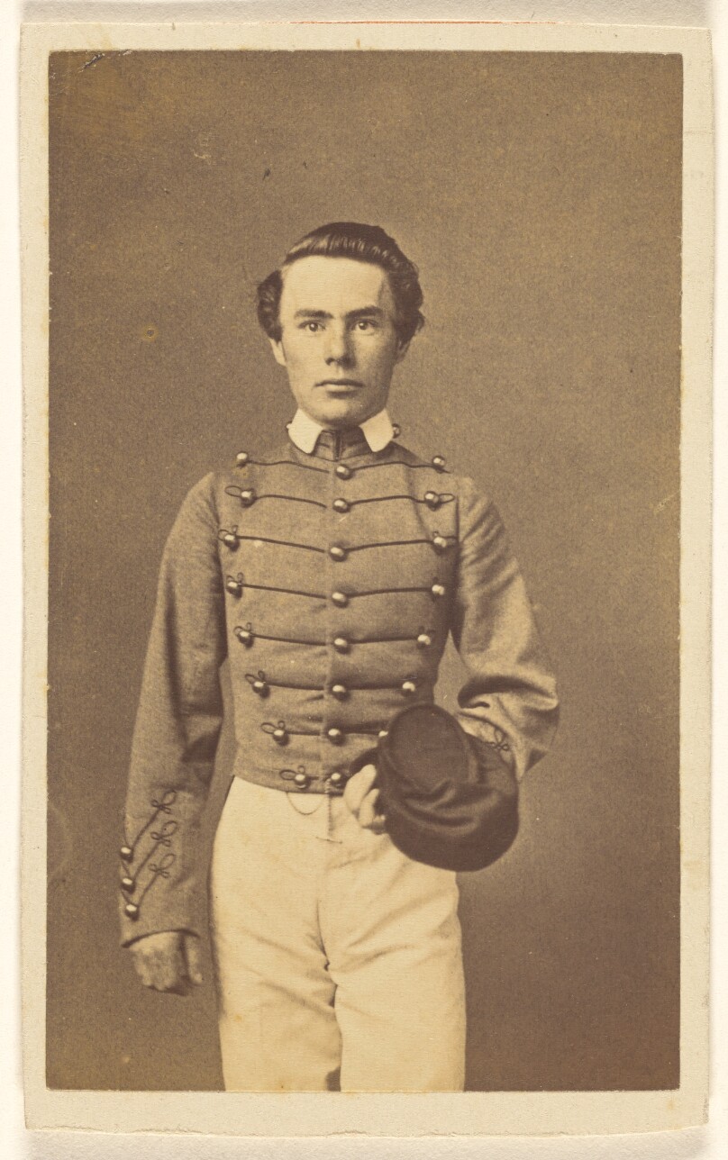 [Unidentified Civil War soldier standing, holding a cap]
