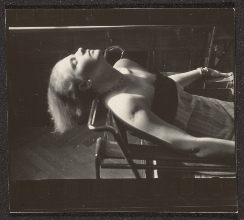 [Contact print from Leica negative: woman seated on Marcel Breuer chair]