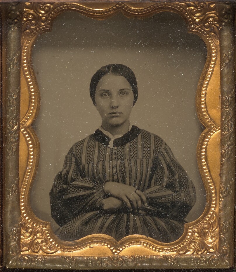 [Young woman seated]