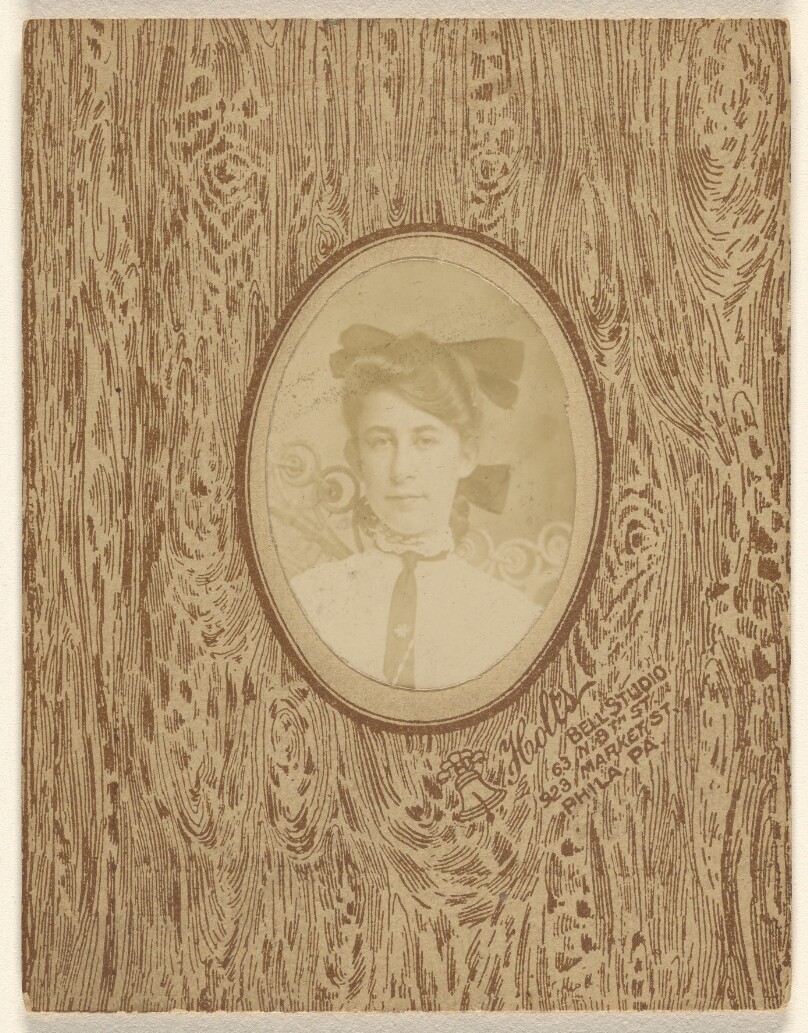 [Unidentified woman wearing a bow tie and a bow in his hair]