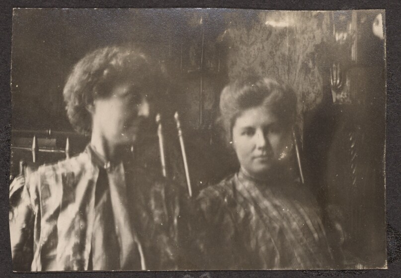 [Two women sitting in a dining room]
