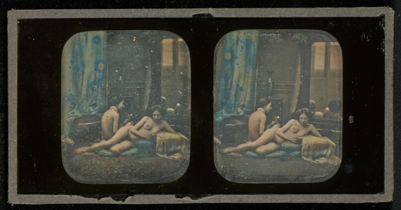 [Two nudes in boudoir studio setting]