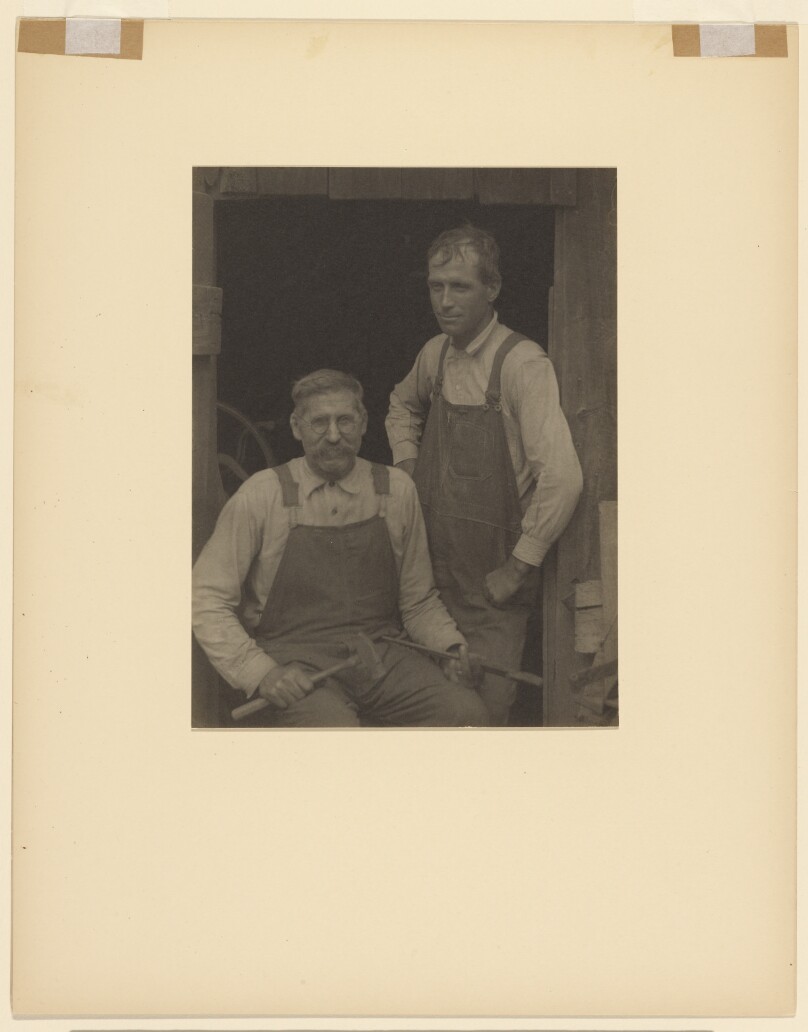 [Two Men in Overalls in Doorway of a Barn]