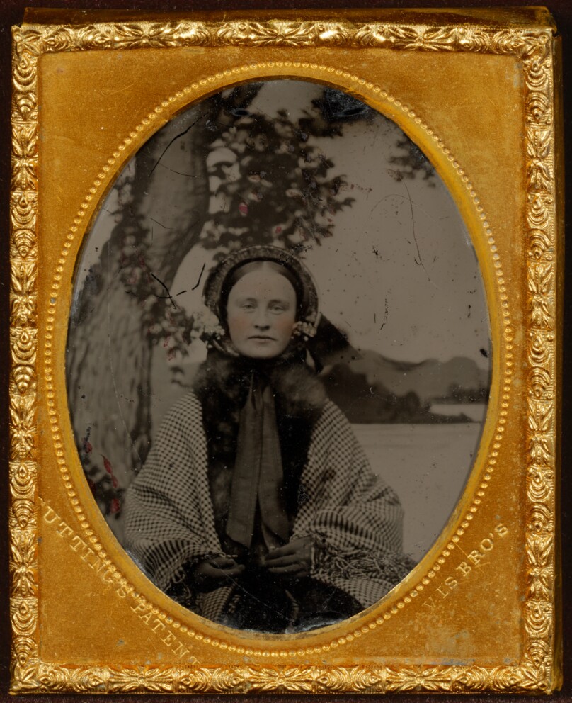 [Portrait of a young woman wearing a bonnet, shawl, and gloves]