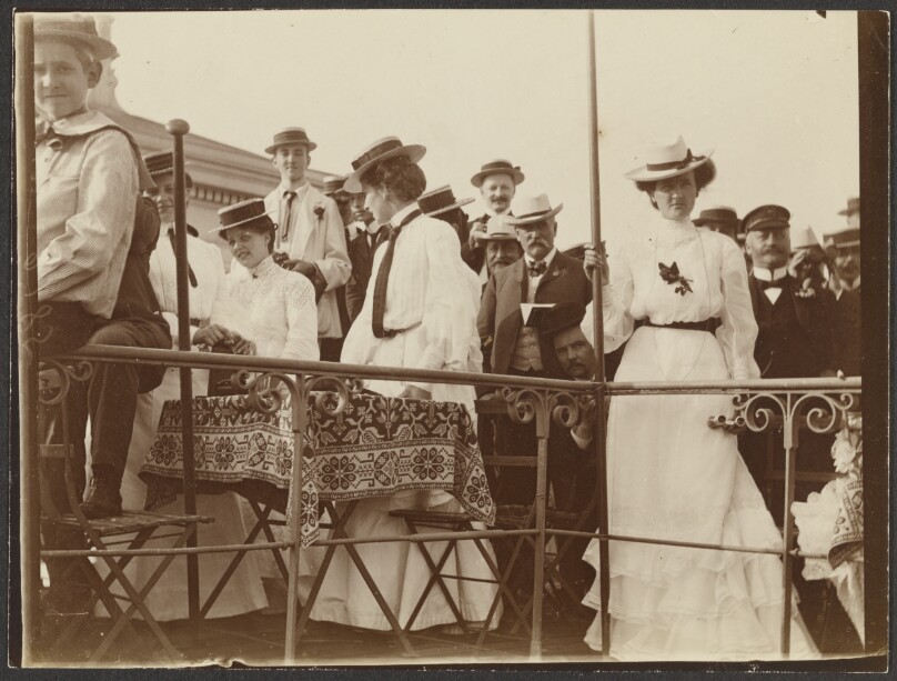 [Men and women gathered on deck]