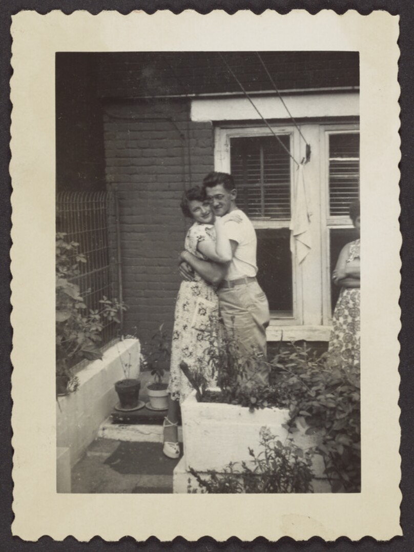[Couple hugging in garden]