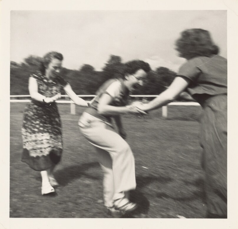 [Three women outside playing]