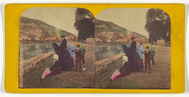 [Two women, one man and three children near a river bank]