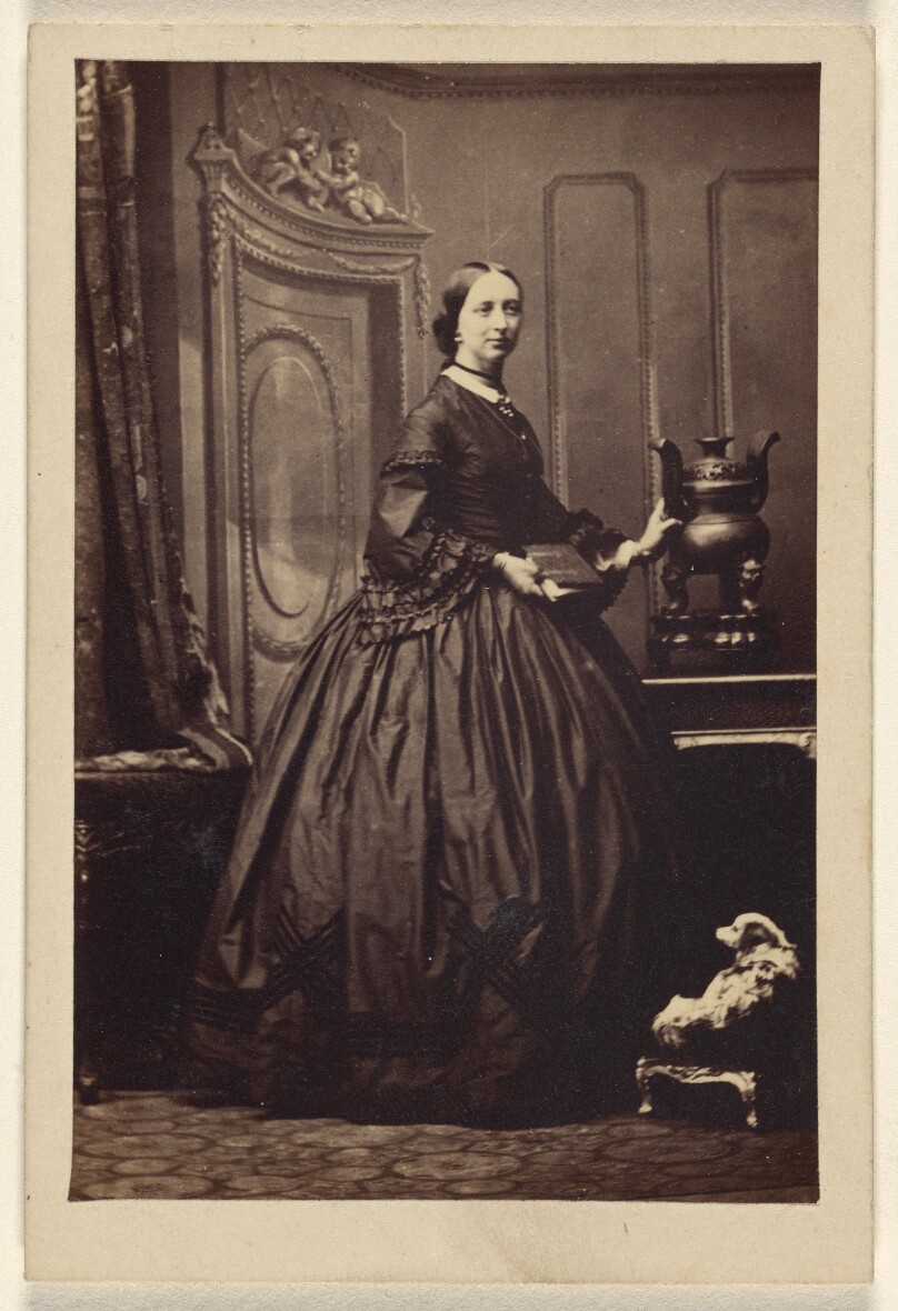 [Unidentified woman holding a book,standing]