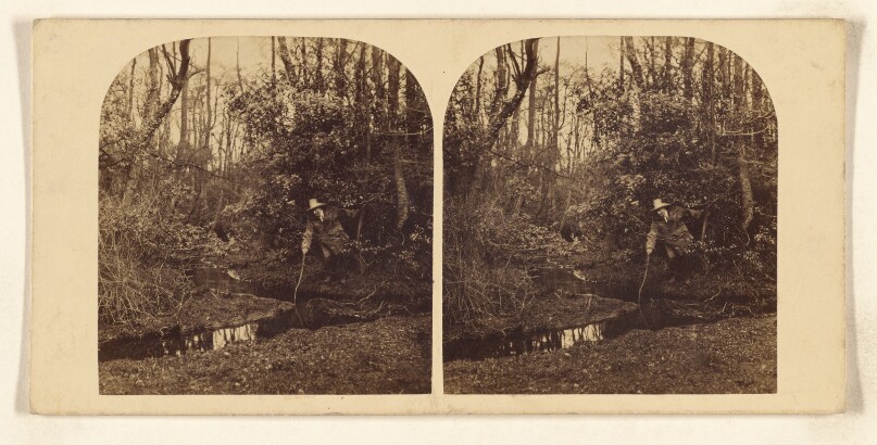 [Man with stick about to ford a stream in the woods]