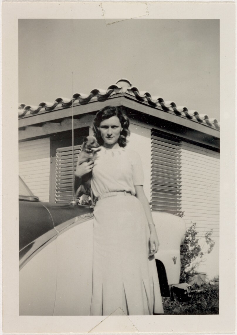 [Woman holding dog]