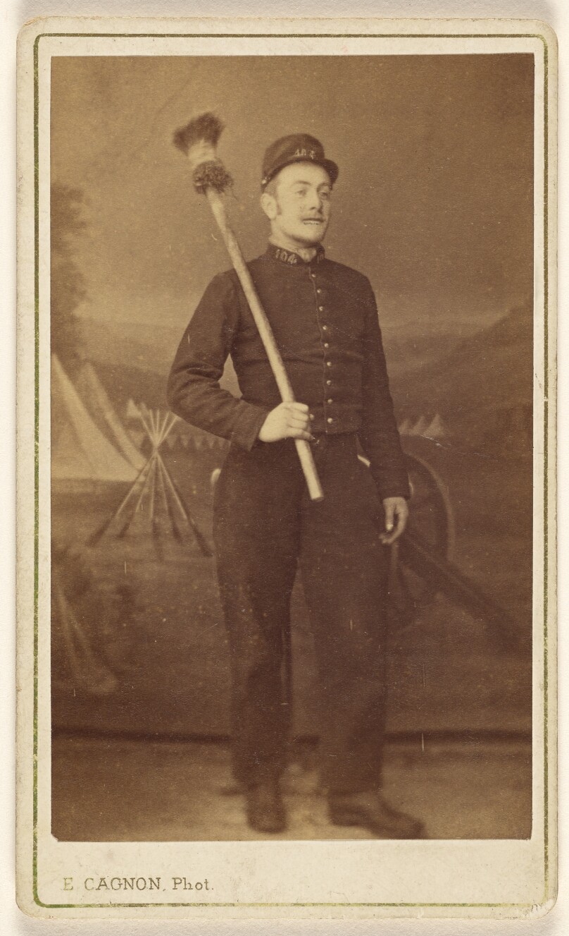 [Unidentified man in uniform standing, with what is possibly a cannon sponge over his shoulder]