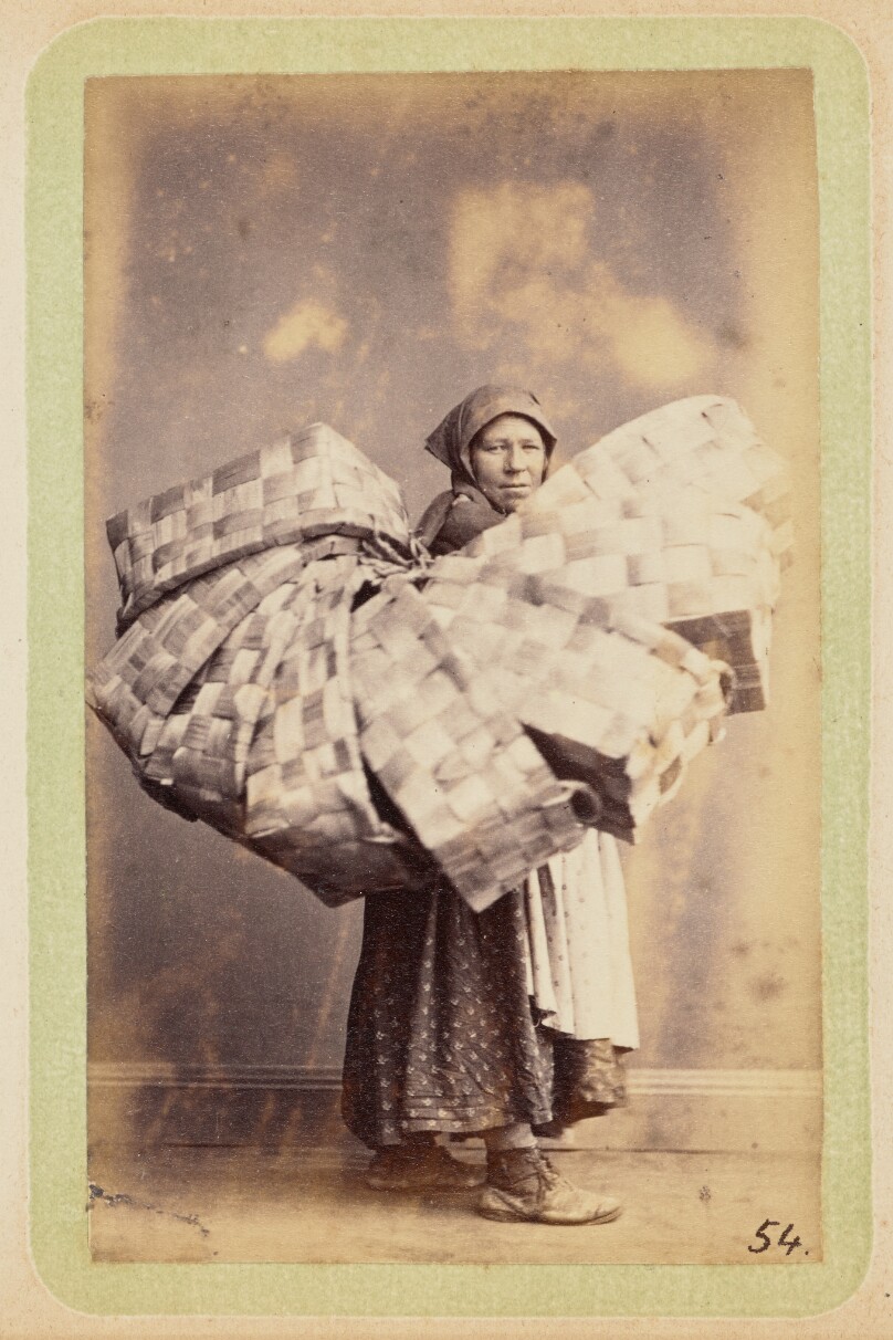 [Woman with woven baskets]