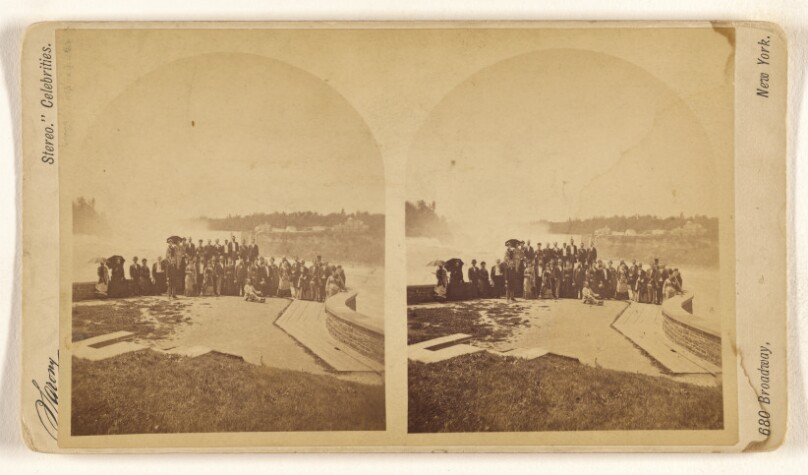 [Large group of people posing in front of Niagara Falls].