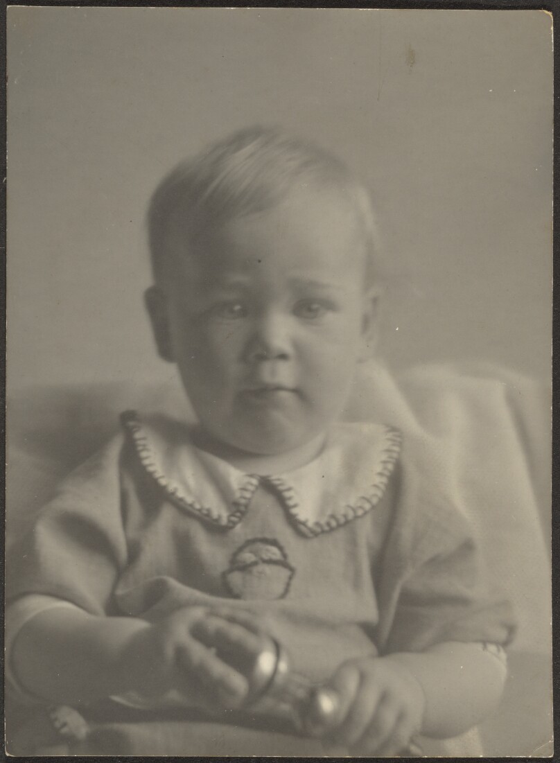[Baby Holding Silver Rattle]
