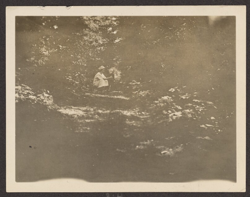 [Woman and child on a wooded path]