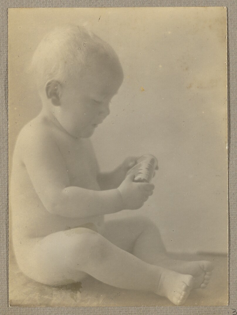 [Neil Weston nude, seated on wood shelf]