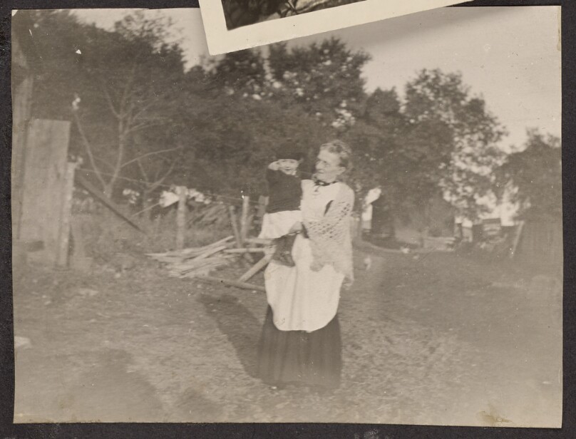 [Elderly woman holding a child]