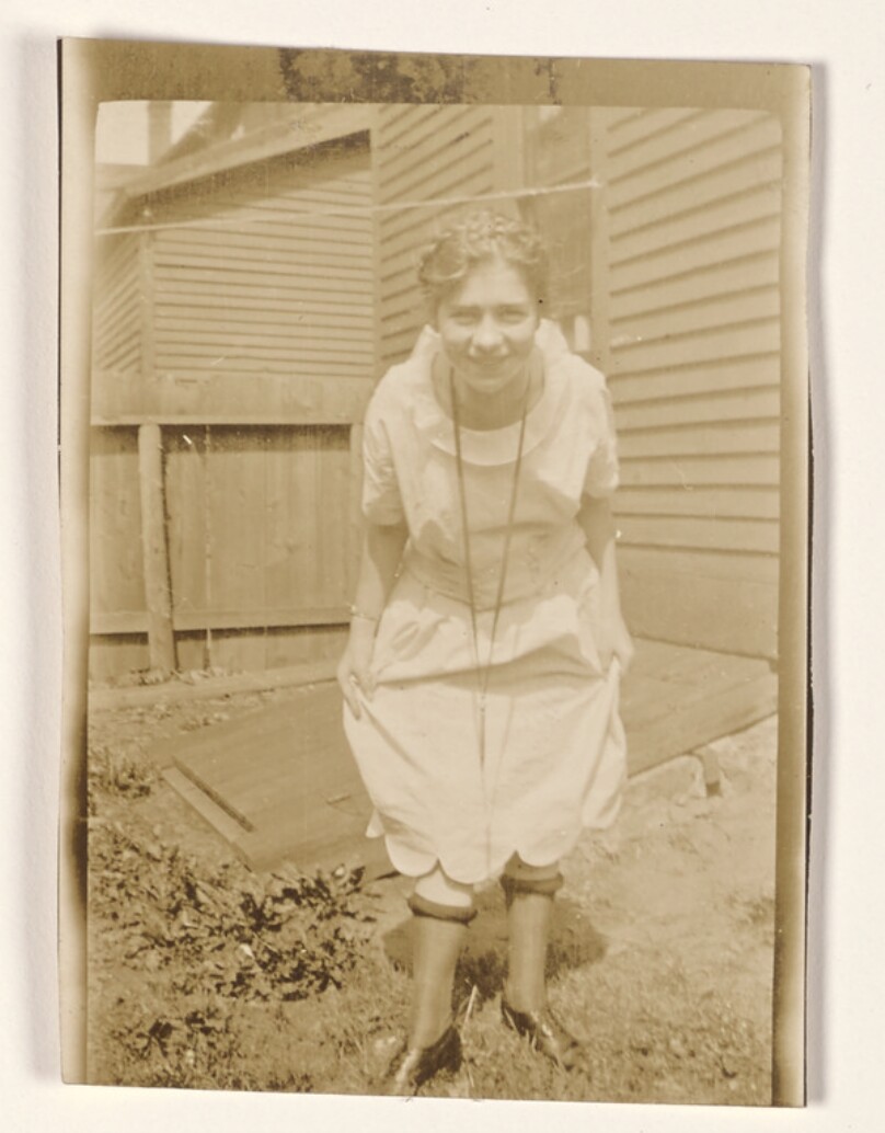 [Woman posing in a yard]