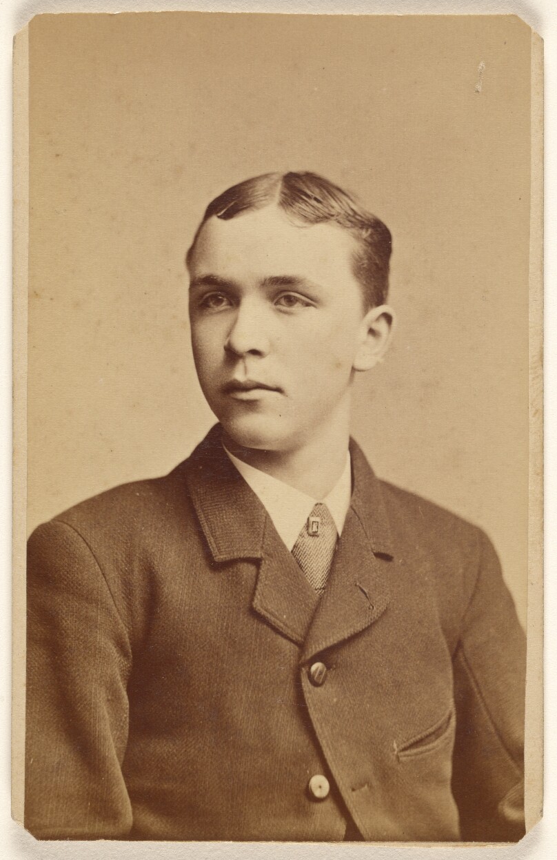 [Unidentified man in 3/4 profile, seated]