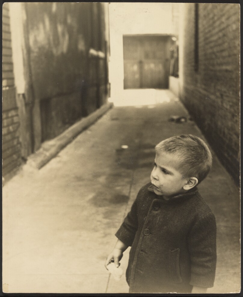 [Young boy in alley]