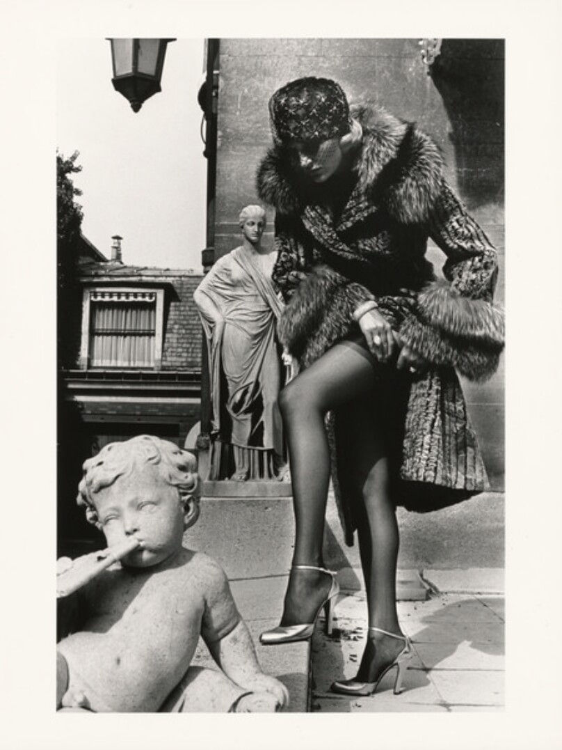 Woman in Fur Coat Adjusting Stocking