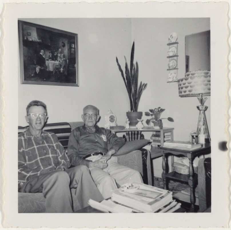 [Two Men Seated on Couch]