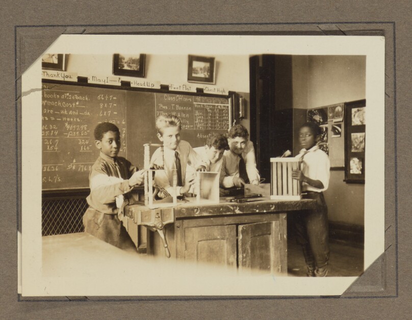 [Five students in a classroom]