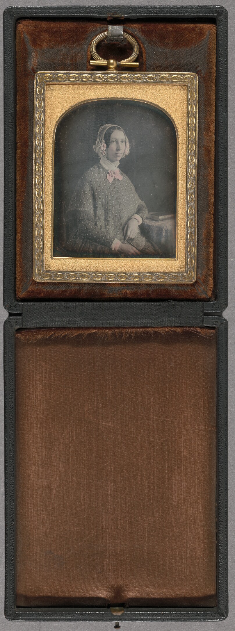 [Portrait of a young woman wearing a floral bonnet, seated]