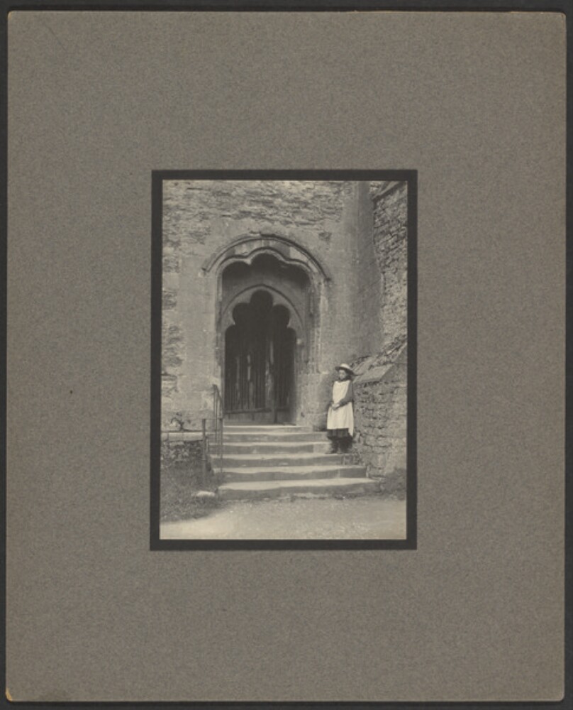 [Girl on steps in front of doorway]