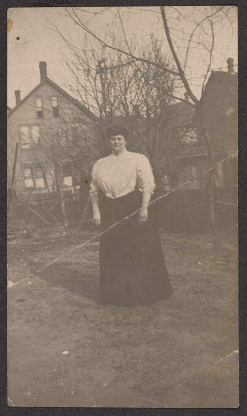 [Woman standing in a yard]