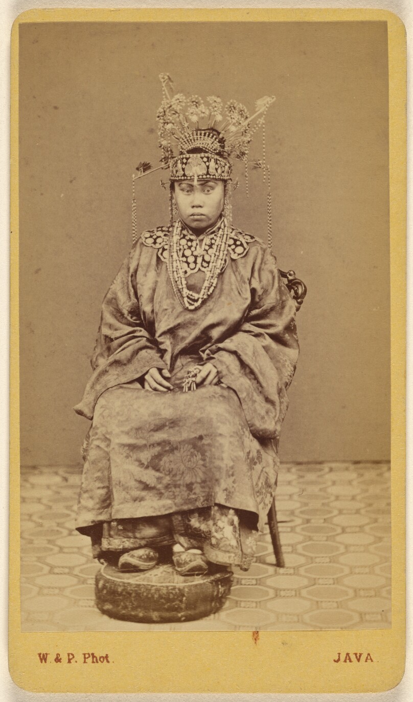[Javanese woman wearing an ornate headdress, seated]