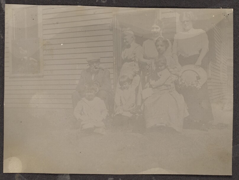 [Group portrait outside a house]