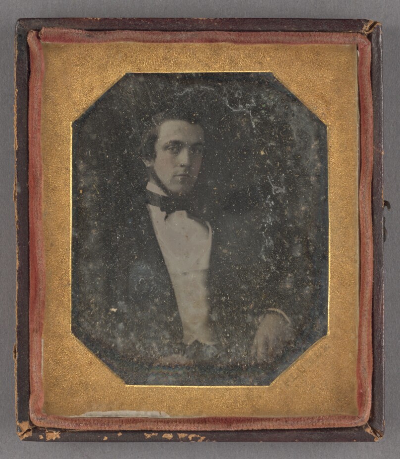 [Portrait of a seated man with a chin beard]